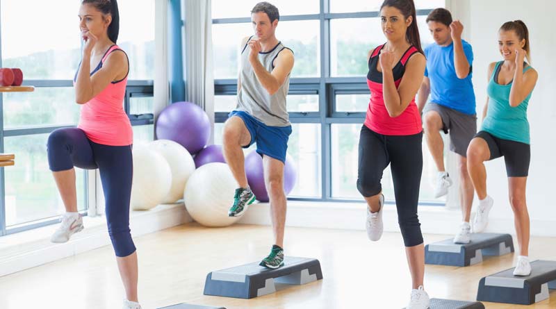 Young men and women working out in an aerobics class