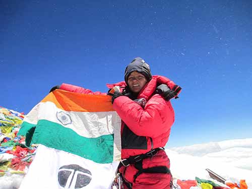 Arunimha Sinha with the Indian flag at the top of Mount Everest