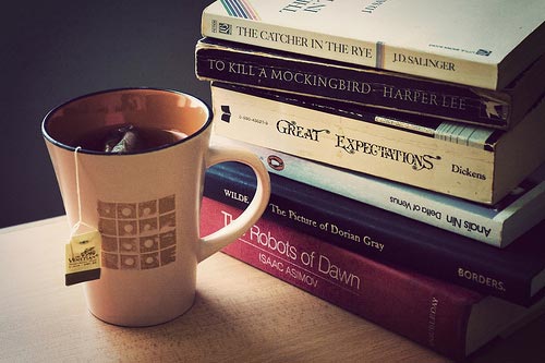 Cup of tea near a stack of books