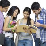 A group of four college students studying together