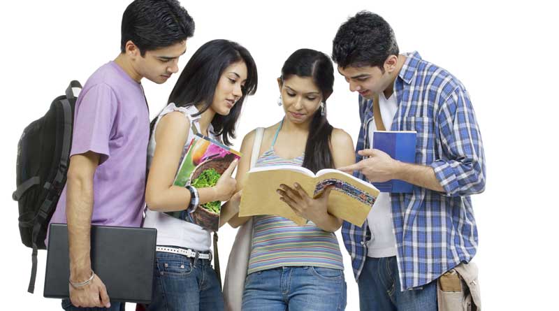 A group of four college students studying together