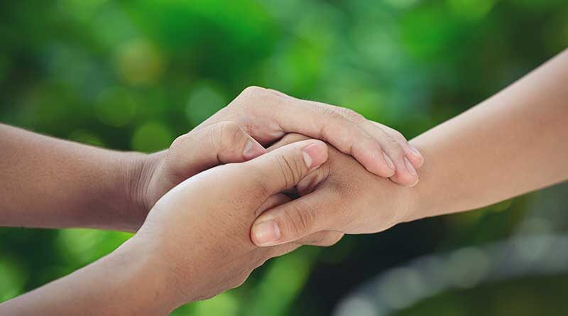 Hands holding on to one another