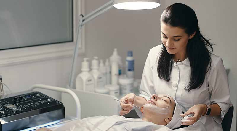 Female dermatologist with patient