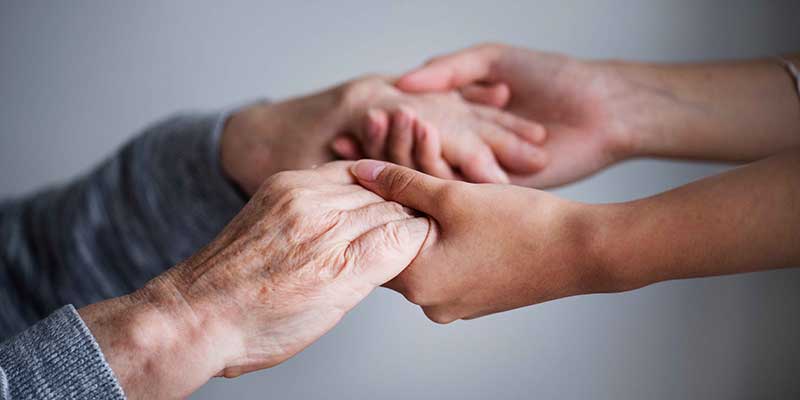 Old hands being held by younger ones