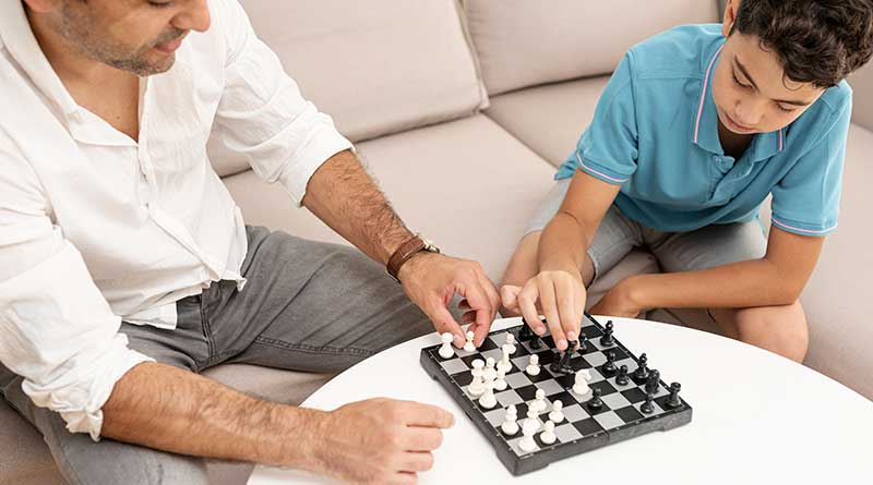 Father and son playing chess