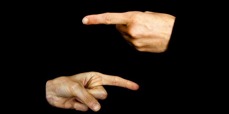 Fingers of two hands pointing at each other