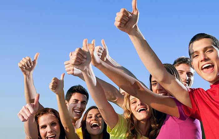 Group of friends giving thumbs up