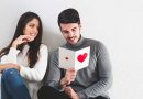 Girl smiling at a boy holding a Valentine's Day card.
