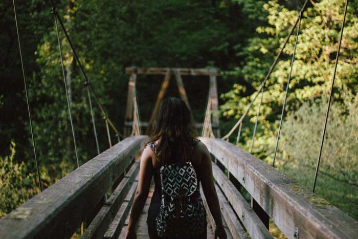 Girl walking on bridge into the unknown