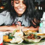 Girl smiling as she looks at her food