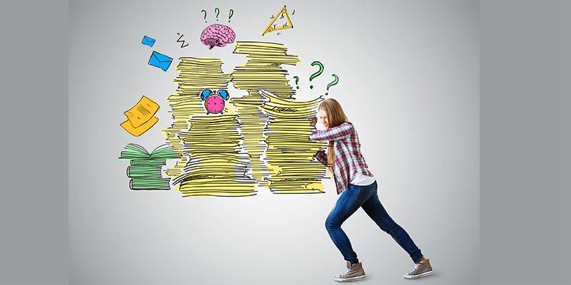 Girl pushing away a stack of papers and other work