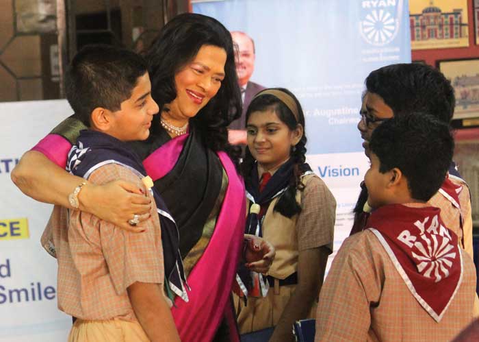 Grace Pinto, MD, Ryan International Group with students