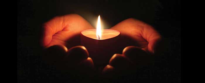 Hands holding a candle