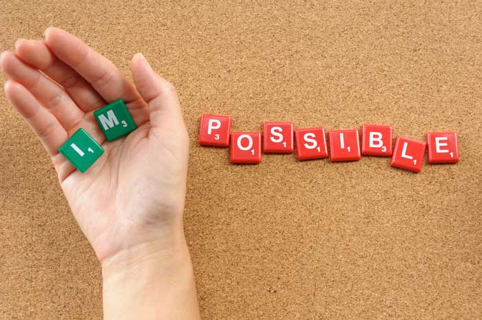 Hand holding the words I'm possible
