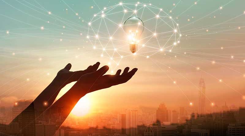 Hand holding brain digital network with light bulb inside