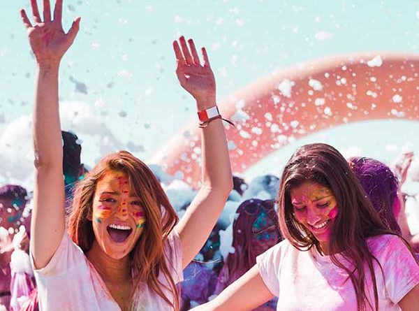 Happy girls playing Holi with colour on their faces