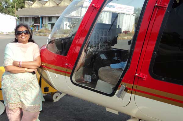 Leena Juvekar Duttagupta near Adonis Aviation helicopter