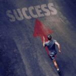 Man running on arrow towards the word success