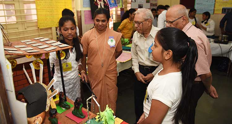 Senior scientist, Dr A. M. Bhagwat, views the exhibition