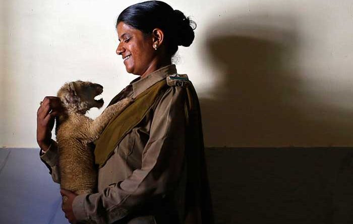Rasila Wadher carrying a lion cub
