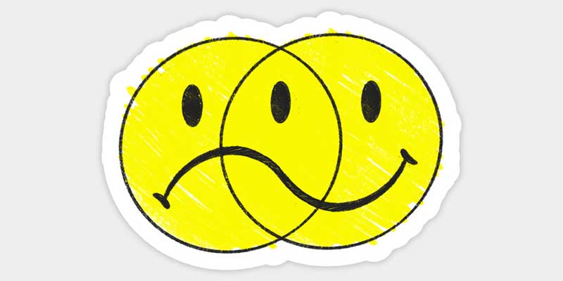 Sad and happy faces intertwined