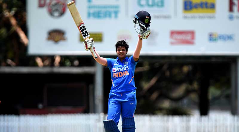 Shafali Verma raising her helmet and bat