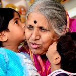 Sindhutai kissing two small children