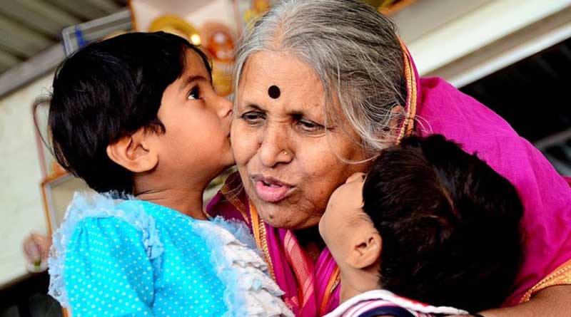 Sindhutai kissing two small children