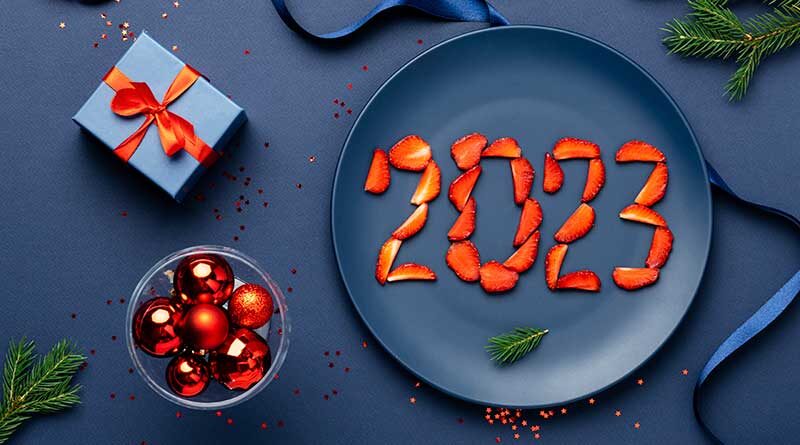 Strawberries in the shape of the year 2023 on a blue plate