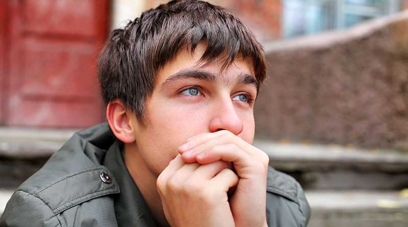 Stressed out and anxious young man sitting on the steps