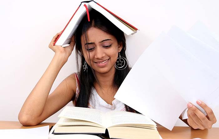 Teen girl looking anxious while preparing for exams