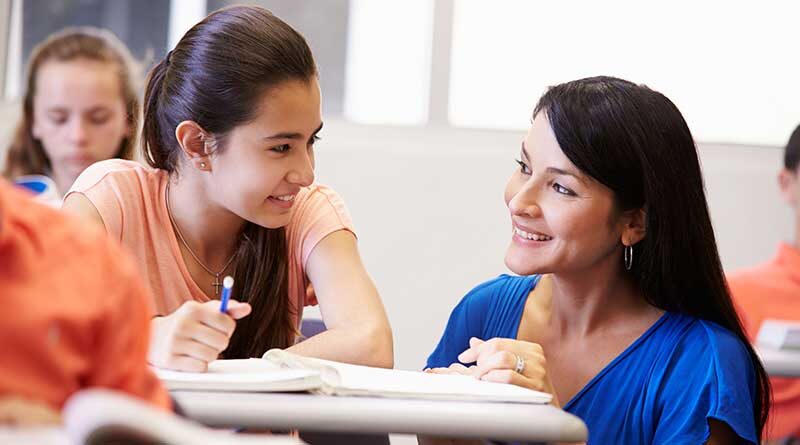 Student and teacher interacting in a classroom