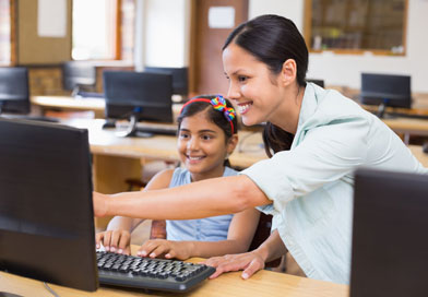 Teacher and student in computer class