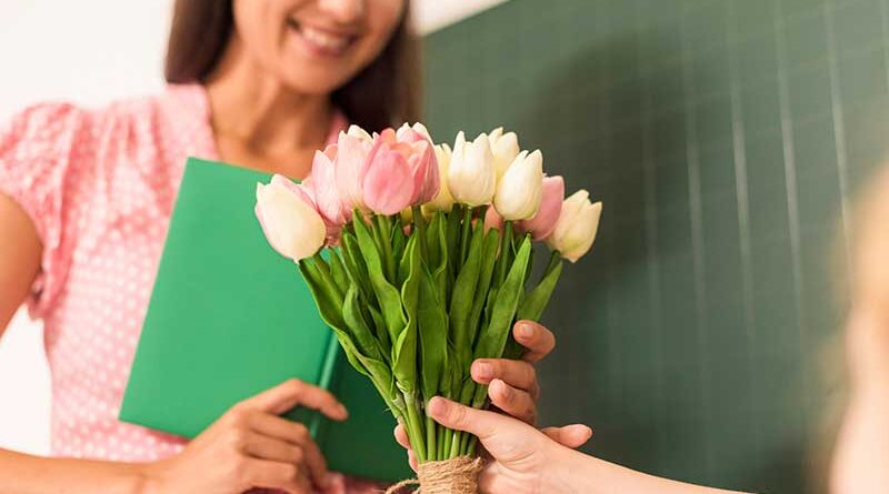 Student gifting flowers to teacher on Teachers' Day