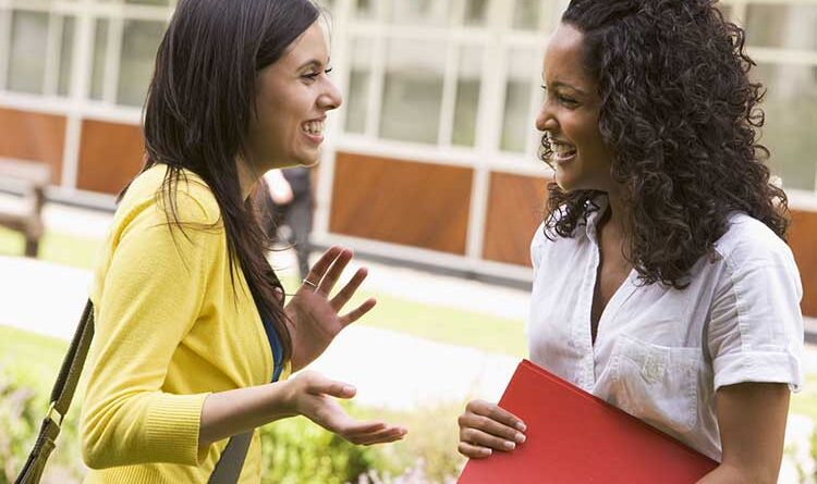 Two young women talking animatedly with gestures