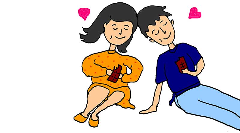 Young couple in love eating chocolate