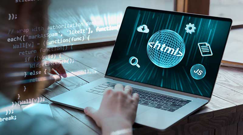 Woman coding and programming for the web on a laptop