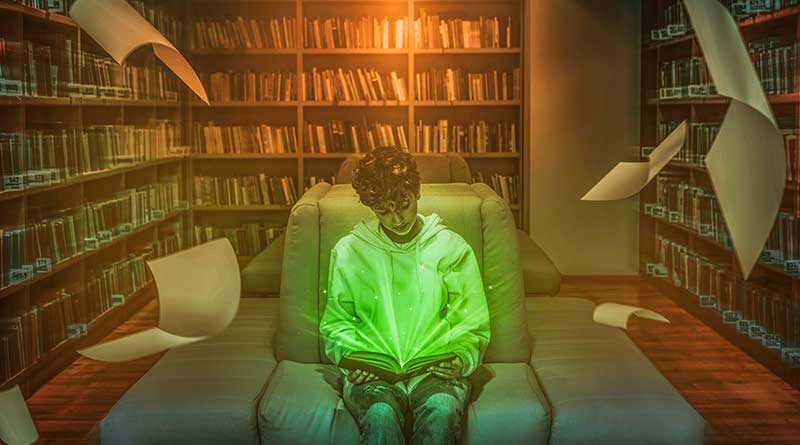 Young boy reading in a library