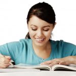 Young girl happily studying