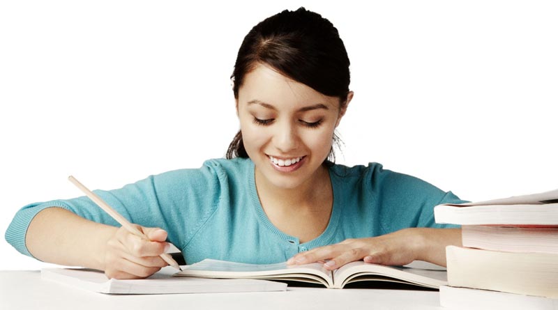 Young girl happily studying