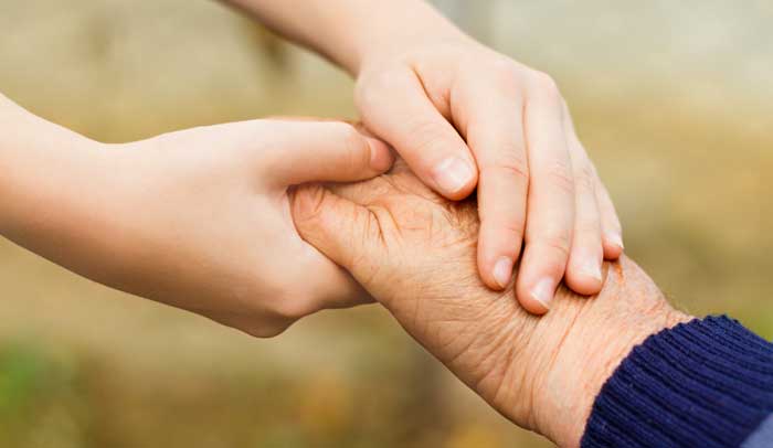 Young hand holding old hand