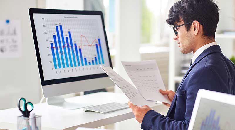 Young male data scientist analyzing date online