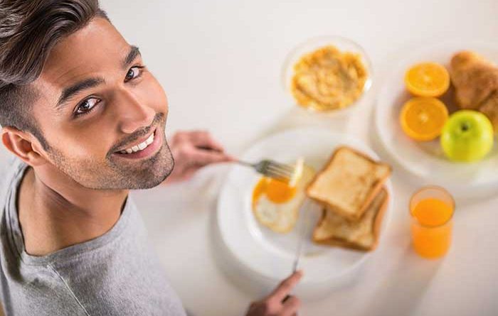 Young man eating a healthy breakfast