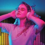 Young woman listening to music on the headphones