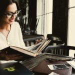 Young woman looking at old photos and reliving memories of the past