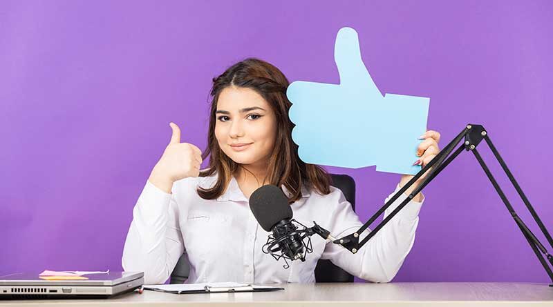 Young woman holding up a thumbs up sign