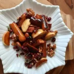 White plate with Apple and Sausage Salad on it.