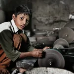 Boy working in a factory