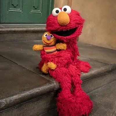 Elmo sitting on steps