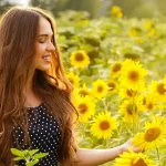 Girl walking in a field of sunflowers